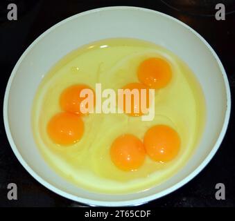 Three eggs with double yolk in a pan Stock Photo