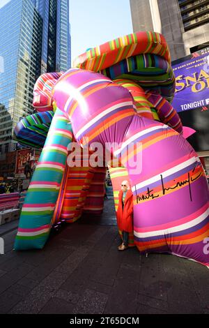New York, USA. , . Argentinian conceptual pop artist Marta Minujín, 80, poses next to her 'Sculpture of Dreams' installation in Times Square. The vibrant, large-scale, 16-piece inflatable in the artist's signature stripes is Minujín's first public sculpture in New York City in her sixty-year career, and is presented to coincide with the Jewish Museum's major survey exhibition of her work, Marta Minujín: Arte! Arte! Arte!, opening on November 17. Credit: Enrique Shore/Alamy Live News Stock Photo