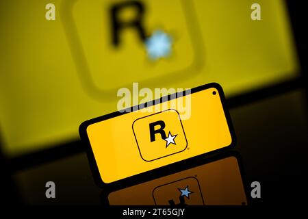 Rockstar games company logo on screen. Rockstar is international computer games developer Stock Photo
