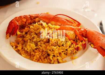 Paella con bogavante ( Paella with lobster) served on plate Stock Photo