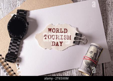 World Tourism Day Typography. Ripped Paper Between Flat Lay Summer Beach Accessories. Stock Photo