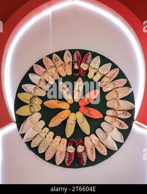 London, UK. 08th Nov, 2023. An artfully arranged display of traditional shoes at the Morocco booth. As every year, in the last couple of hours on the final day of World Travel Market at ExCel London many country booths and travel show stands hold informal gatherings and wrap parties to celebrate a successful three days of the trade show, often with performances, music, dancing and local food and drinks. Credit: Imageplotter/Alamy Live News Stock Photo