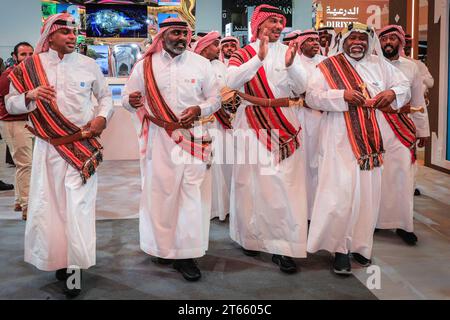 London, UK. 08th Nov, 2023. A group of Saudi men perform a traditional dance and song. As every year, in the last couple of hours on the final day of World Travel Market at ExCel London many country booths and travel show stands hold informal gatherings and wrap parties to celebrate a successful three days of the trade show, often with performances, music, dancing and local food and drinks. Credit: Imageplotter/Alamy Live News Stock Photo