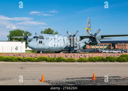 C-130 cargo plan behind a brick wall with a Wyoming Air National Guard sign in Cheyenne, Wyoming Stock Photo