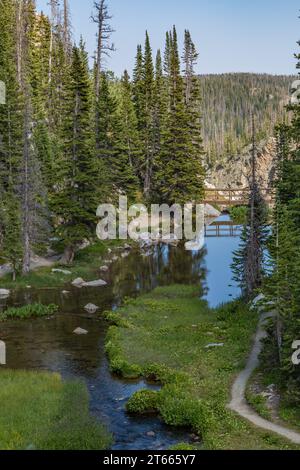 Pedestrian bridge over waters from the Lake Marie runoff at the Medicine Bow National Forest in Wyoming Stock Photo