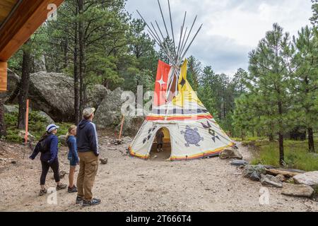 Children play in a Native American teepee display along the Presidential Trail at Mount Rushmore National Monument near Keystone, South Dakota Stock Photo