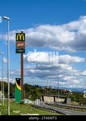 Rome, Italy - 09 august 2023: McDonalds logo on a pole near the highway in the mountains Stock Photo