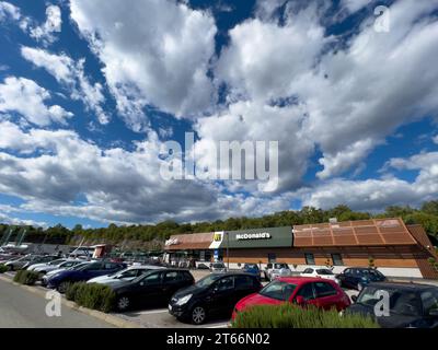 Rome, Italy - 09 august 2023: Large crowded parking lot with cars near the McDonalds building Stock Photo
