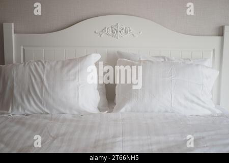 white pillow lined up on bed  Stock Photo