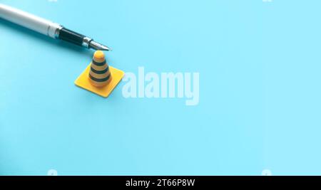 Fixing, maintenance and under construction concept.  Pen and traffic cones. Stock Photo
