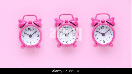 Pink alarm clock over a pink background. Stock Photo