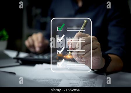 Businessman signing electronic document with digital signature checklist quality investment approval, executing plan, project approved. Stock Photo