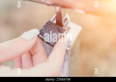 Wedding heart golden lock on stainless iron fence valentines day symbol of eternal love a wedding Stock Photo