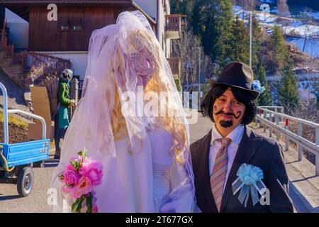 Valfloriana, Italy - February 26, 2022: Carnival participants costumed as bride and groom, in the Valfloriana carnival, Trentino, Northern Italy Stock Photo