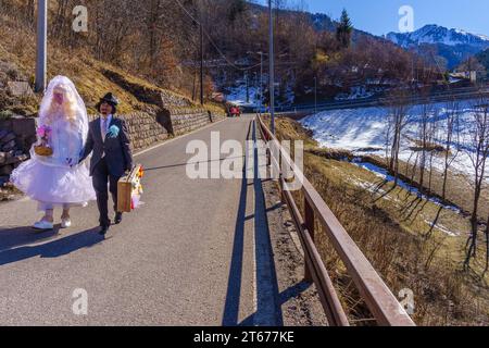 Valfloriana, Italy - February 26, 2022: Carnival participants costumed as bride and groom, in the Valfloriana carnival, Trentino, Northern Italy Stock Photo