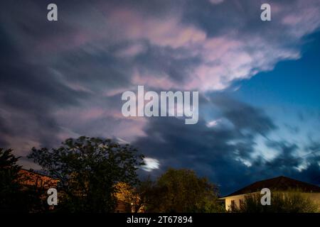Long exposure of heavy storm clouds at night. Stock Photo