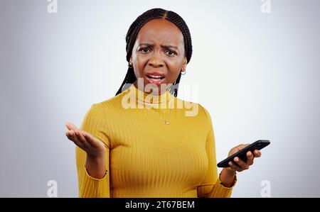Phone text, black woman and confused portrait from scam conversation and anxiety from problem and fail. Studio, white background and frustrated female Stock Photo