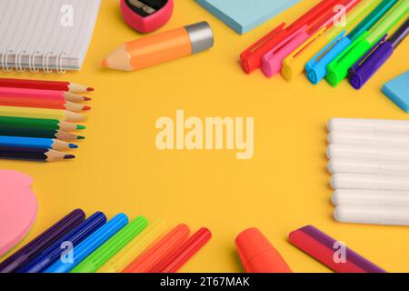 Frame made of different school stationery on yellow background, closeup and space for text. Back to school Stock Photo