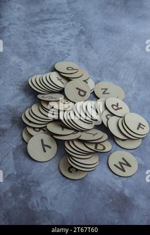 Wooden tiles with alphabet letters scattered on white background Stock ...