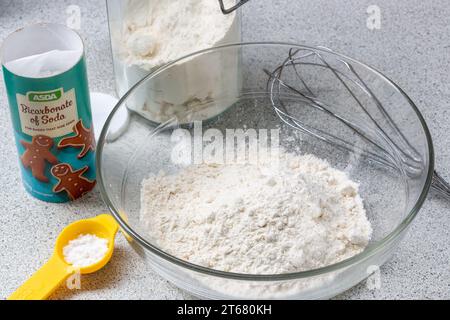 Sodium bicarbonate (sodium hydrogencarbonate), commonly known as baking soda or bicarbonate of soda ready to add to flour Stock Photo