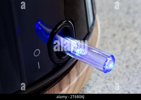 Electric Kettle power on button glowing blue Stock Photo