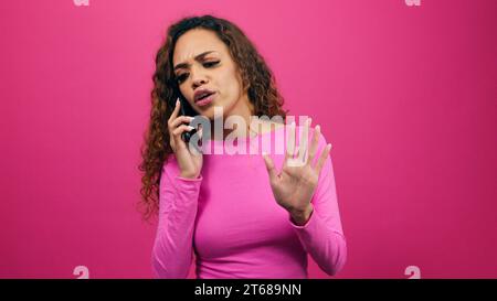 Young woman fighting on the phone, talking and getting upset, give attitude Stock Photo