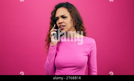 Young woman fighting on the phone, talking and getting upset, give attitude Stock Photo