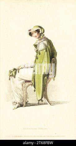 Regency woman in carriage dress, 1813. Robe of jaconot muslin with needlework vandyke, Russian mantle of pomona green sarsnet, trimmed with rich frog fringe, cottage slouch bonnet, green slippers, primrose kid gloves. Plate 30, April 1 1813. Handcoloured copperplate engraving by Thomas Uwins from Rudolph Ackermann's Repository of Arts, London. Stock Photo