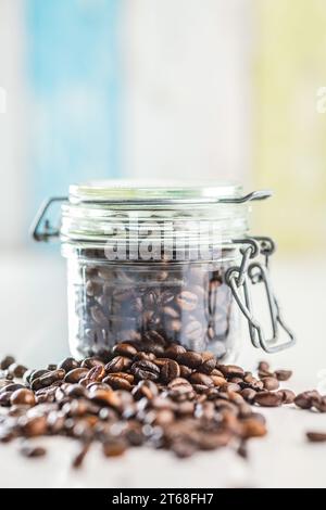 Roasted coffee beans on the white kitchen table. Stock Photo