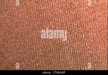Closeup of Red Brown Colored Jeans Fabric Texture with Selective Focus Stock Photo