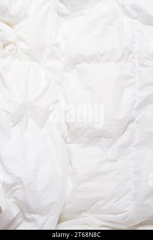 Top view of bedding sheets crease, white blanket texture. Close up of bedding sheets with copy-space Stock Photo
