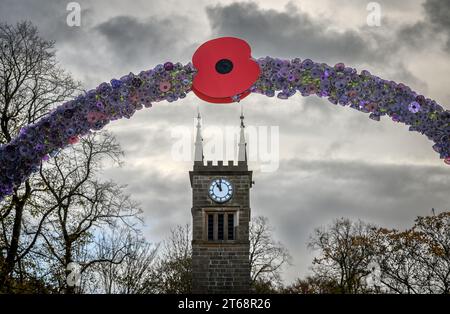 Bolton, UK. 9th November 2023. Locals from the village of Rigley, Bolton, have decorated the ancient Rigley Old Bridge over the River Irwell with a waterfall of red poppies and an arch of purple poppies as part of their annual Remembrance commemorations. Credit: Paul Heyes/Alamy Live News Stock Photo