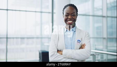 Woman, vote and portrait for politics, arms crossed and badge for support, patriotic and member. Elections, voter choice and campaign for democracy Stock Photo