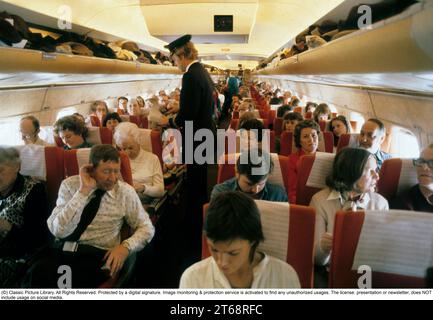 Airline travelling in the 1970s. A swedish passenger airplane 1979 of the airline SAS. The flight attendants is greeting the passangers when boarding the aircraft. Sweden 1979 Stock Photo