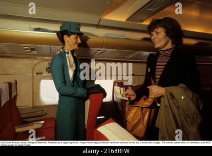 Airline travelling in the 1970s. A swedish passenger airplane 1979 of the airline SAS. The female flight attendant is greeting the passangers when boarding the aircraft. Sweden 1979 Stock Photo