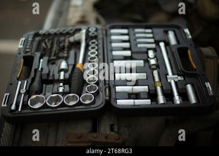 Tool box. Repair keys. Heads for unscrewing nuts. Repair kit. Chrome-plated steel. Drawer with bolts. Stock Photo