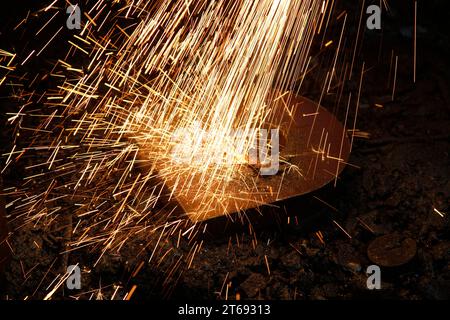 Sparks coming out of metal as a background Stock Photo