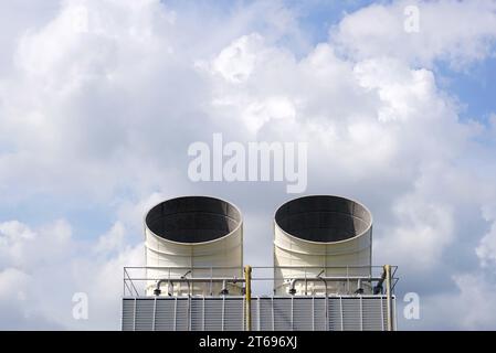 Industrial big chimneys against the blue sky with white clouds, industrial background, environment concepts. Stock Photo