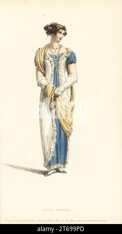Regency woman in full dress. Evening dress of Polonese robe in white crepe over a celestial blue satin slip, hair in the Eastern style with flowers, Grecian scarf, French kid gloves, blue satin slippers. Plate 37, Vol. 9, May 1, 1813. Handcoloured copperplate engraving by Thomas Uwins from Rudolph Ackermann's Repository of Arts, London. Stock Photo