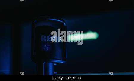 A modern recording studio showcases a professional microphone in the foreground Stock Photo