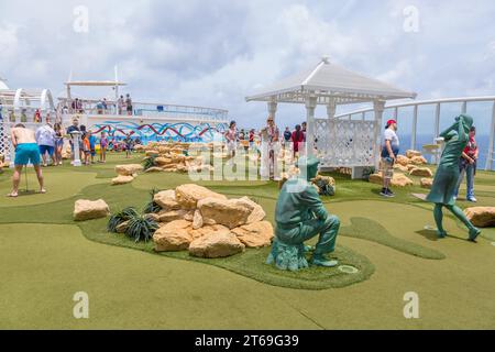 Cruise passengers playing miniature golf on the Royal Caribbean Allure of the Seas cruise ship Stock Photo