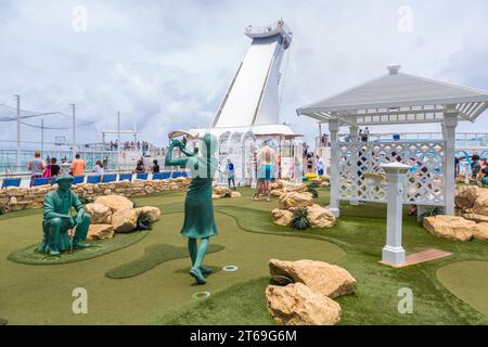 Cruise passengers playing miniature golf on the Royal Caribbean Allure of the Seas cruise ship Stock Photo