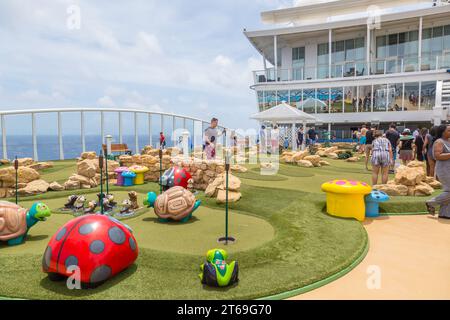 Cruise passengers playing miniature golf on the Royal Caribbean Allure of the Seas cruise ship Stock Photo