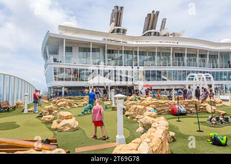 Cruise passengers playing miniature golf on the Royal Caribbean Allure of the Seas cruise ship Stock Photo