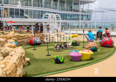 Cruise passengers playing miniature golf on the Royal Caribbean Allure of the Seas cruise ship Stock Photo