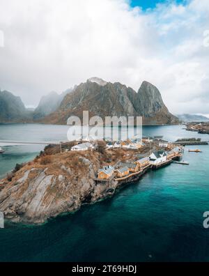 A drone view of vibrant Sakrisoy, Lofoten, with iconic rorbu and yellow houses. Stock Photo