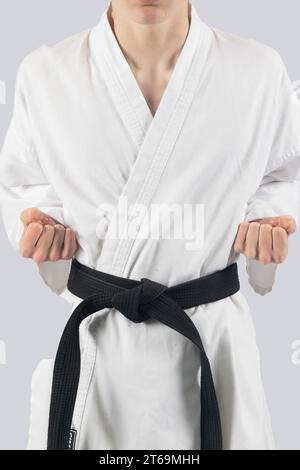 Black belt teenage boy with both hands in chamber Stock Photo