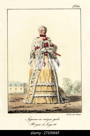 French woman in semi-formal clothes, era of King Louis XV, mid-18th century. Lace bonnet and ruff, cape and gown decorated with lace frills. Dame en demi parure. Regne de Louis XV. Handcoloured lithograph by Lorenzo Bianchi and Domenico Cuciniello after Hippolyte Lecomte from Costumi civili e militari della monarchia francese dal 1200 al 1820, Naples, 1825. Italian edition of Lecomtes Civilian and military costumes of the French monarchy from 1200 to 1820. Stock Photo