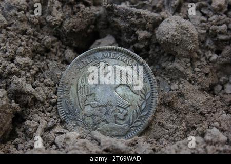 1843 Mexican Libertad Silver Coin on Ground in Dirt Back Stock Photo