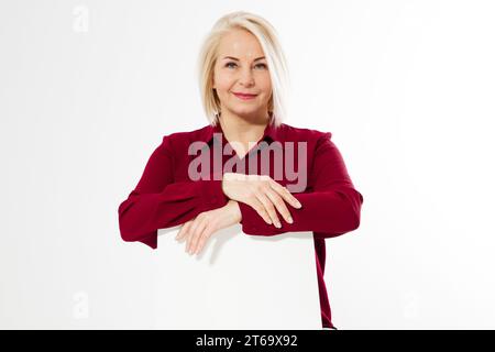 Middle-aged woman sits on a chair and leaned her arms on the back of a chair, middle age female portrait close up Stock Photo